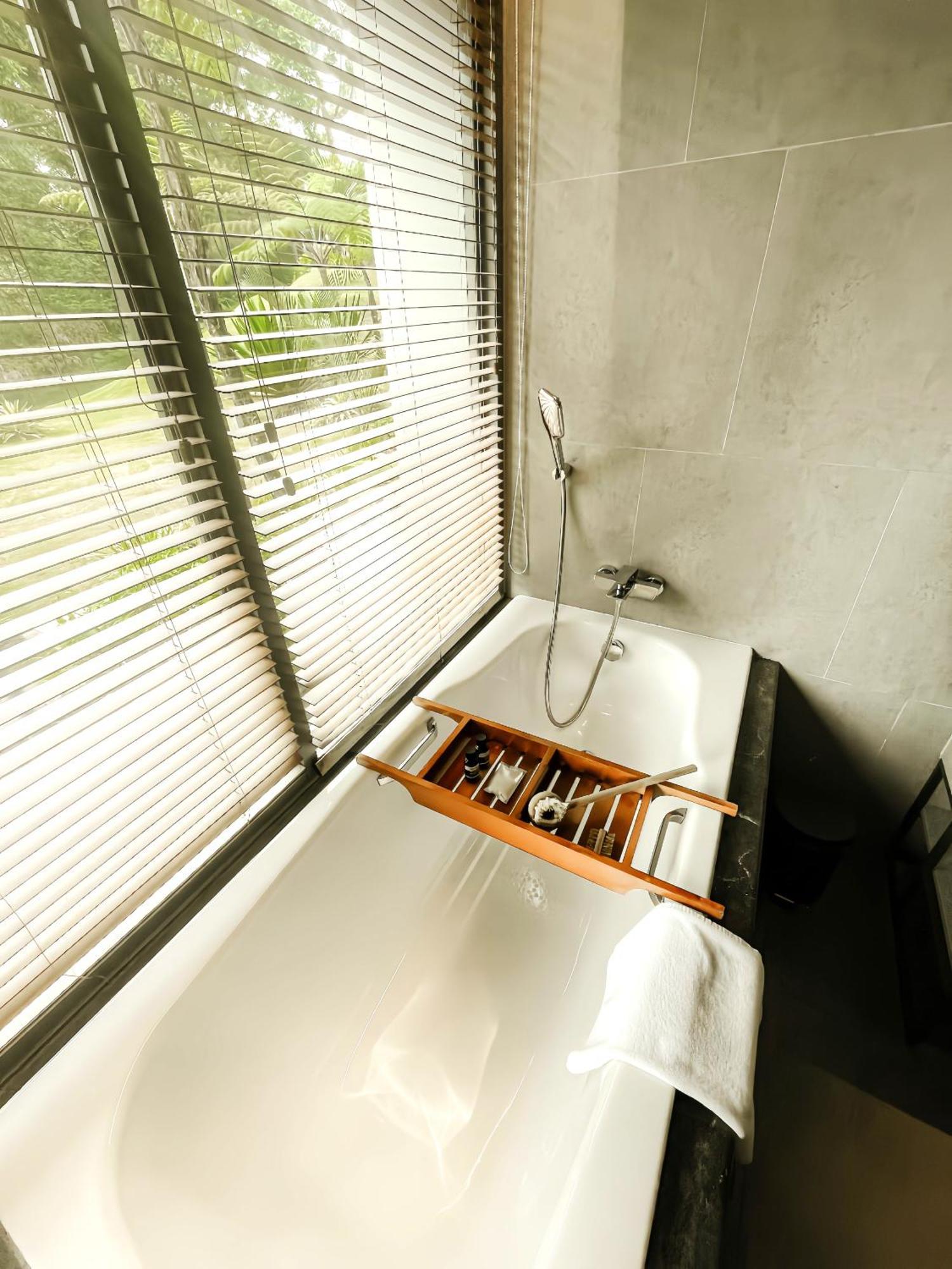 The Botanica Sanctuary Hotel Puncak Cameră foto A bathtub with a shower